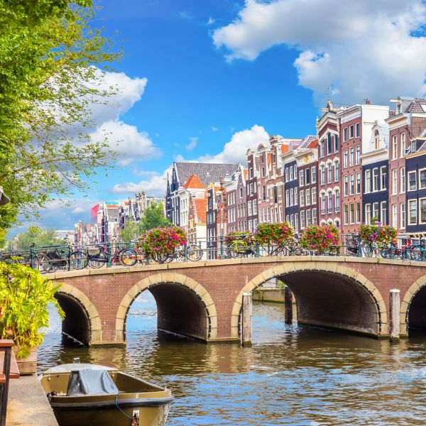 An arched bridge and colourful canal houses in Amsterdam