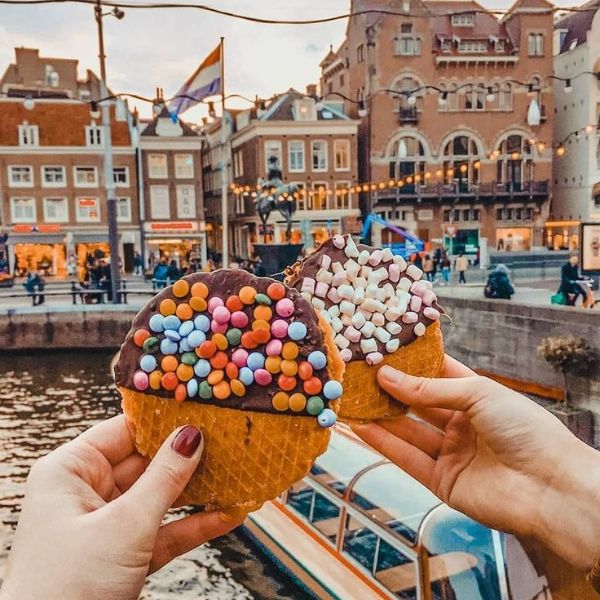 Colourfully topped sweet waffles beside an Amsterdam canal