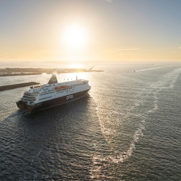 A DFDS ferry sailing in golden evening light