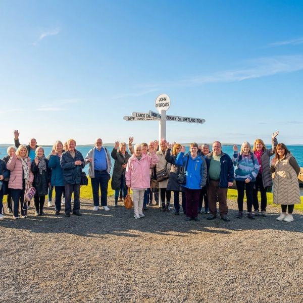 Loch Lomond Travel guests together at the John O'Groats signpost