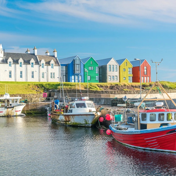 Colourful waterfront buildings and harbour at John O'Groats