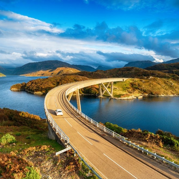 The sweeping curve of Kylesku Bridge amid Highland lochs and hills