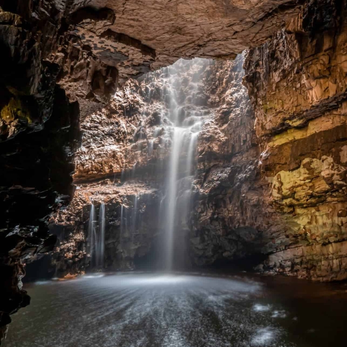 Rock formations and waterfall inside Smoo Cave at Durness