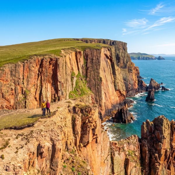 Sunlit cliffs above the turquoise sea in Shetland